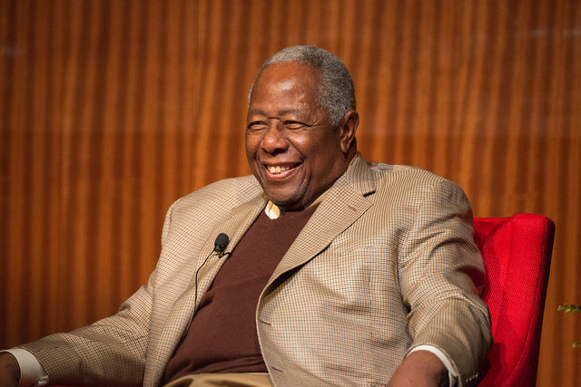 Hank Aaron sitting in a red chair